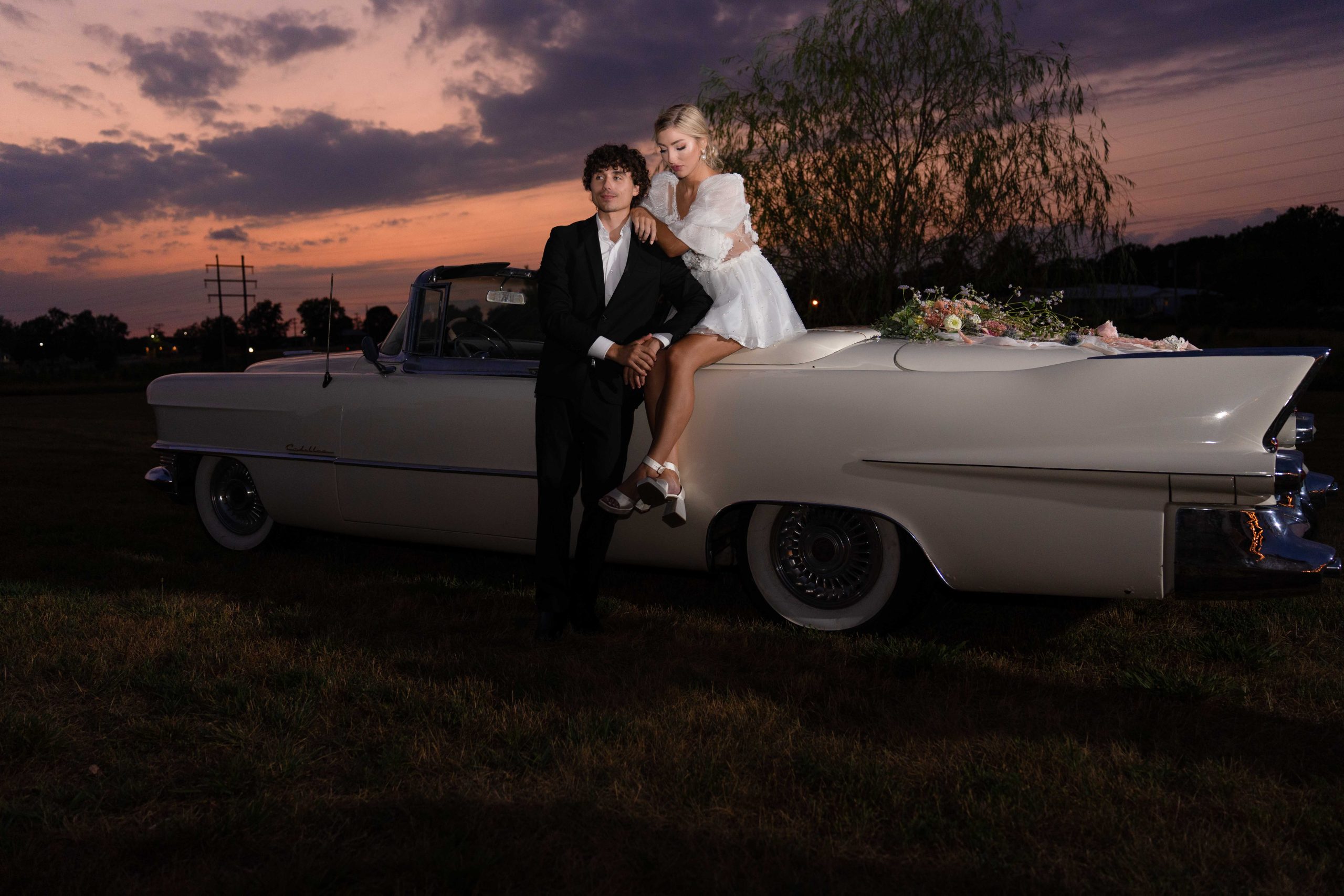 wedding couple photo with classic car at sunset