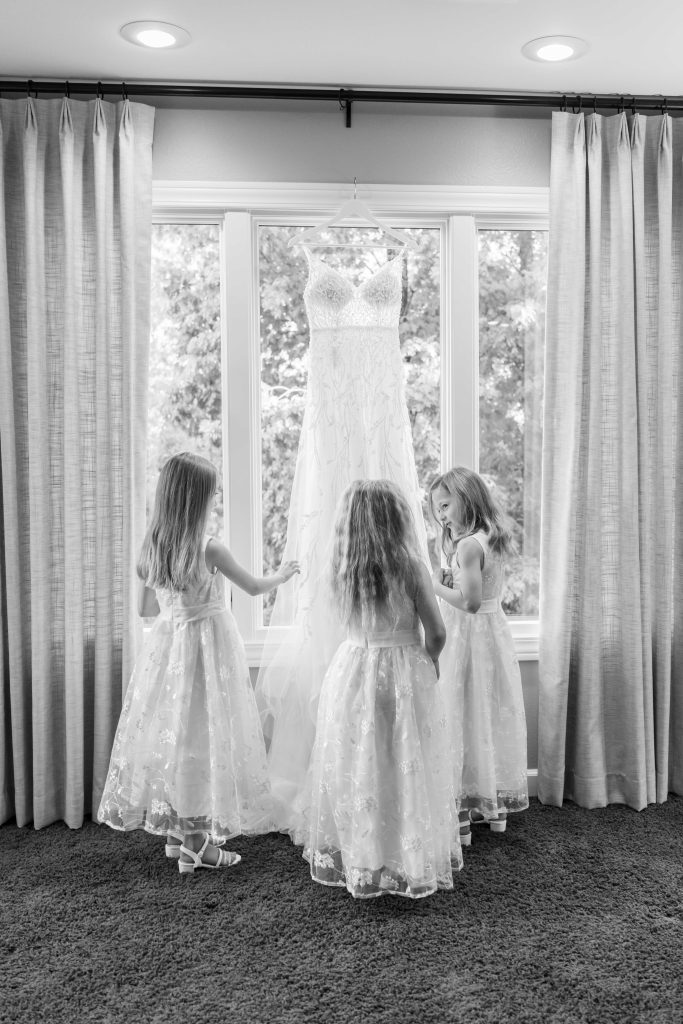 Flower girls looking at bride dress Lake of the Ozarks Wedding Photographer Mitchell Bennett Photography