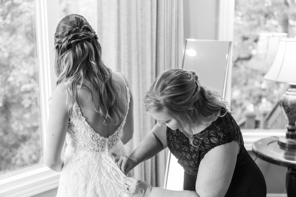 bride getting into dress Lake of the Ozarks Wedding Photographer Mitchell Bennett Photography