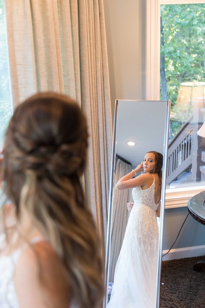 bride looking in mirror by Lake of the Ozarks Wedding Photographer Mitchell Bennett Photography