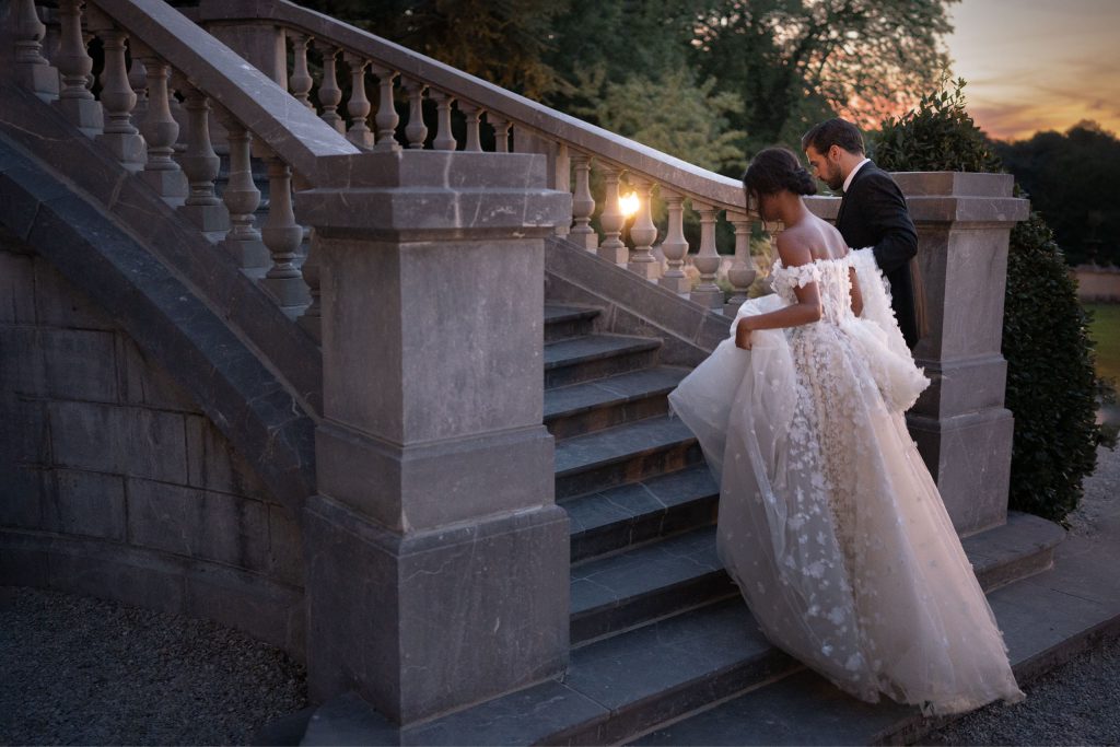 elegant staircase with bride and groom by lake of the Ozarks wedding photographer Mitchell Bennett Photography